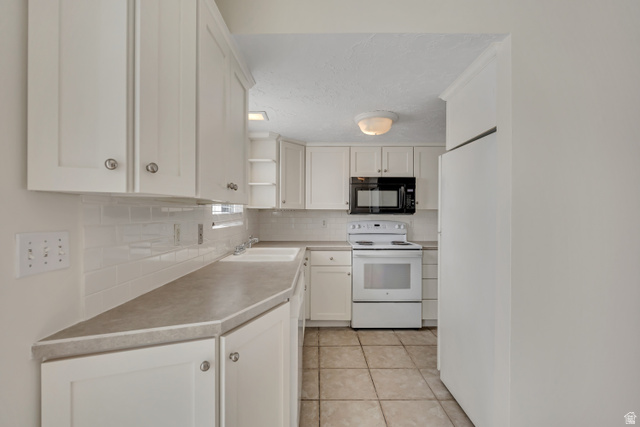 3166 Linden Street Bountiful, UT 84010 - Photo 6 of 25 Kitchen with white appliances, white cabinets, open shelves, light tile patterned floors, and decorative backsplash