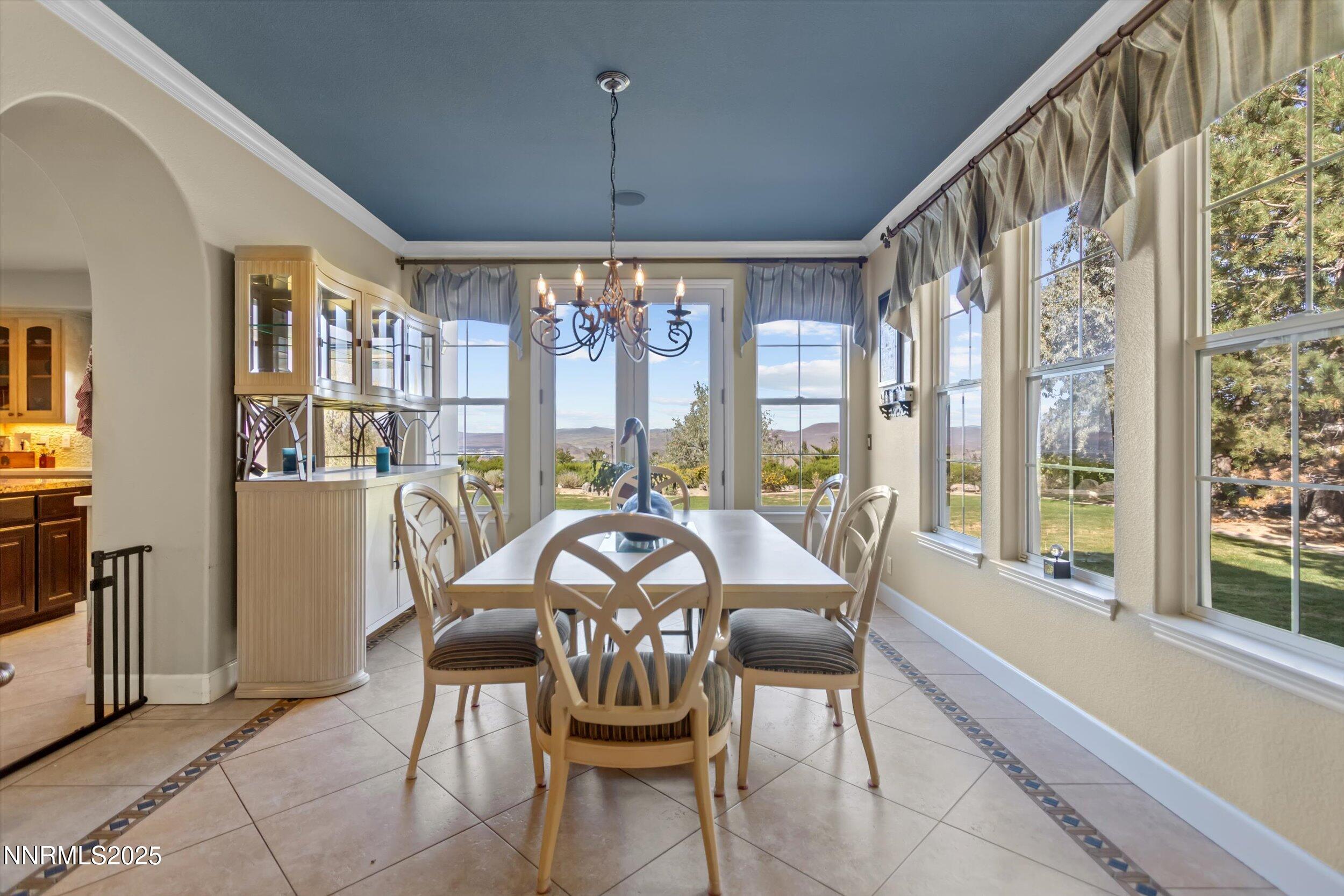 2966 Eagle Rock Court Reno, NV 89511 - Photo 14 of 73 a view of a dining room with furniture large windows and chandelier