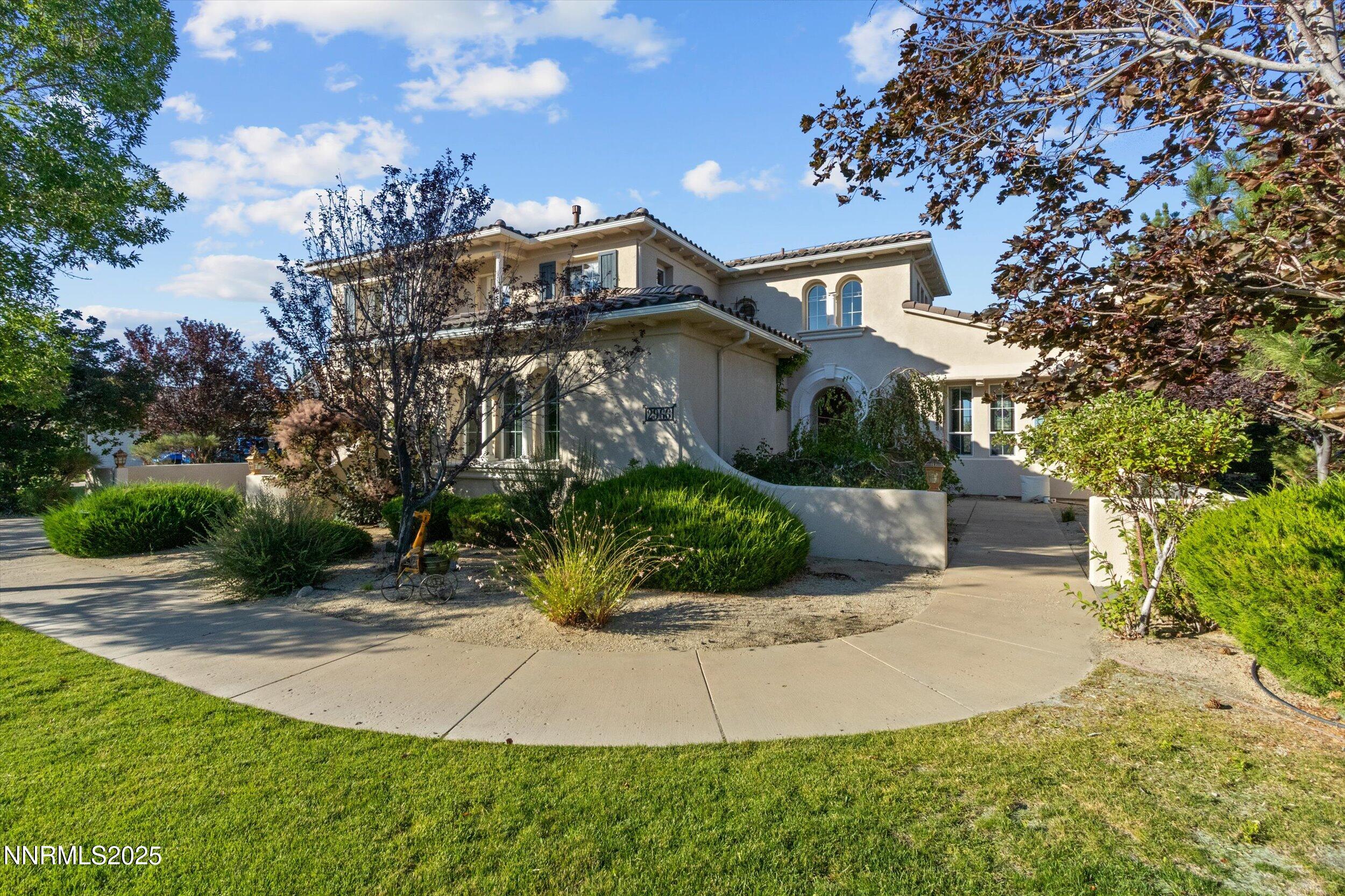 2966 Eagle Rock Court Reno, NV 89511 - Photo 4 of 73 a front view of a house with a yard and potted plants