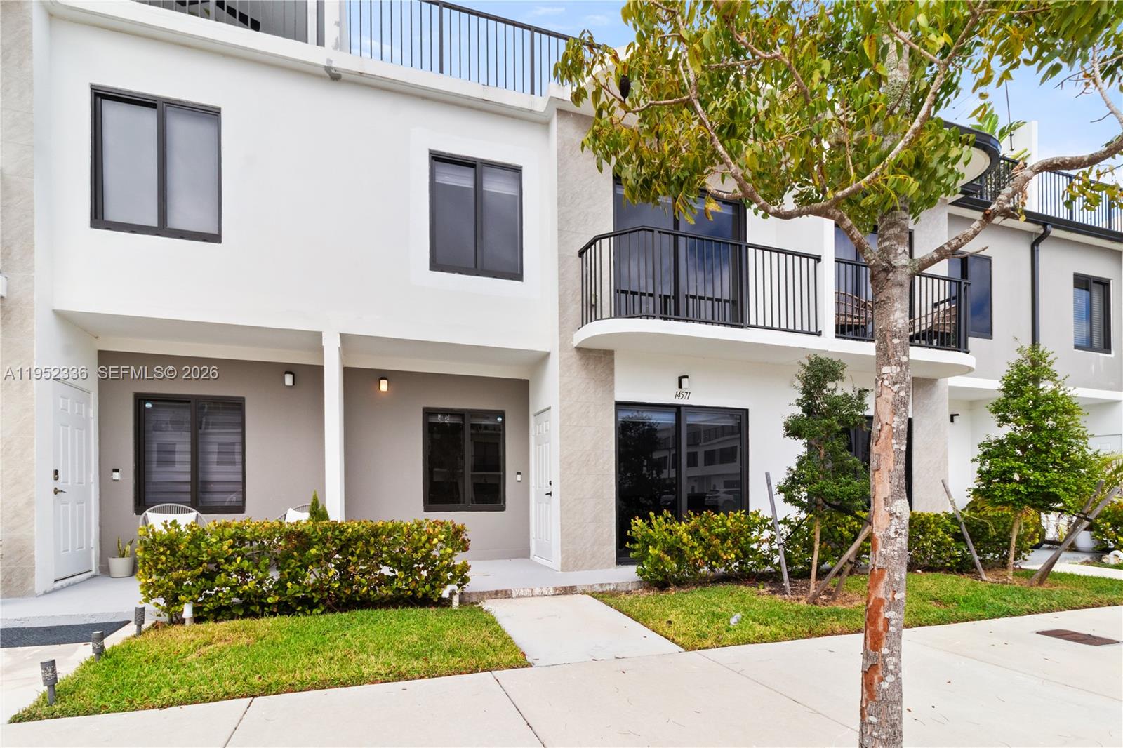 a front view of a house with garden