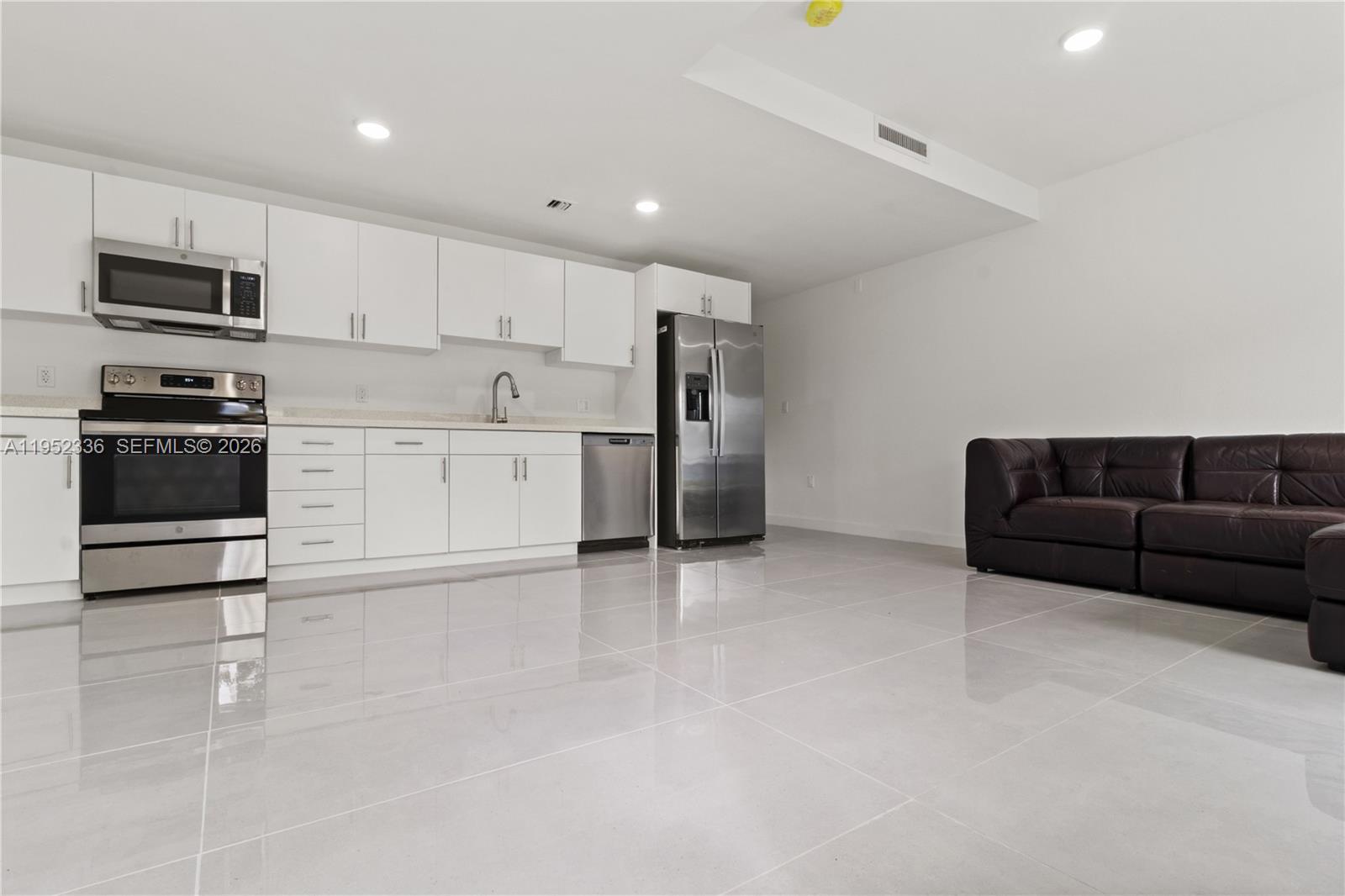 14571 Southwest 261st Street Homestead, FL 33032 - Photo 2 of 30 a kitchen with stainless steel appliances granite countertop a stove a sink and a refrigerator
