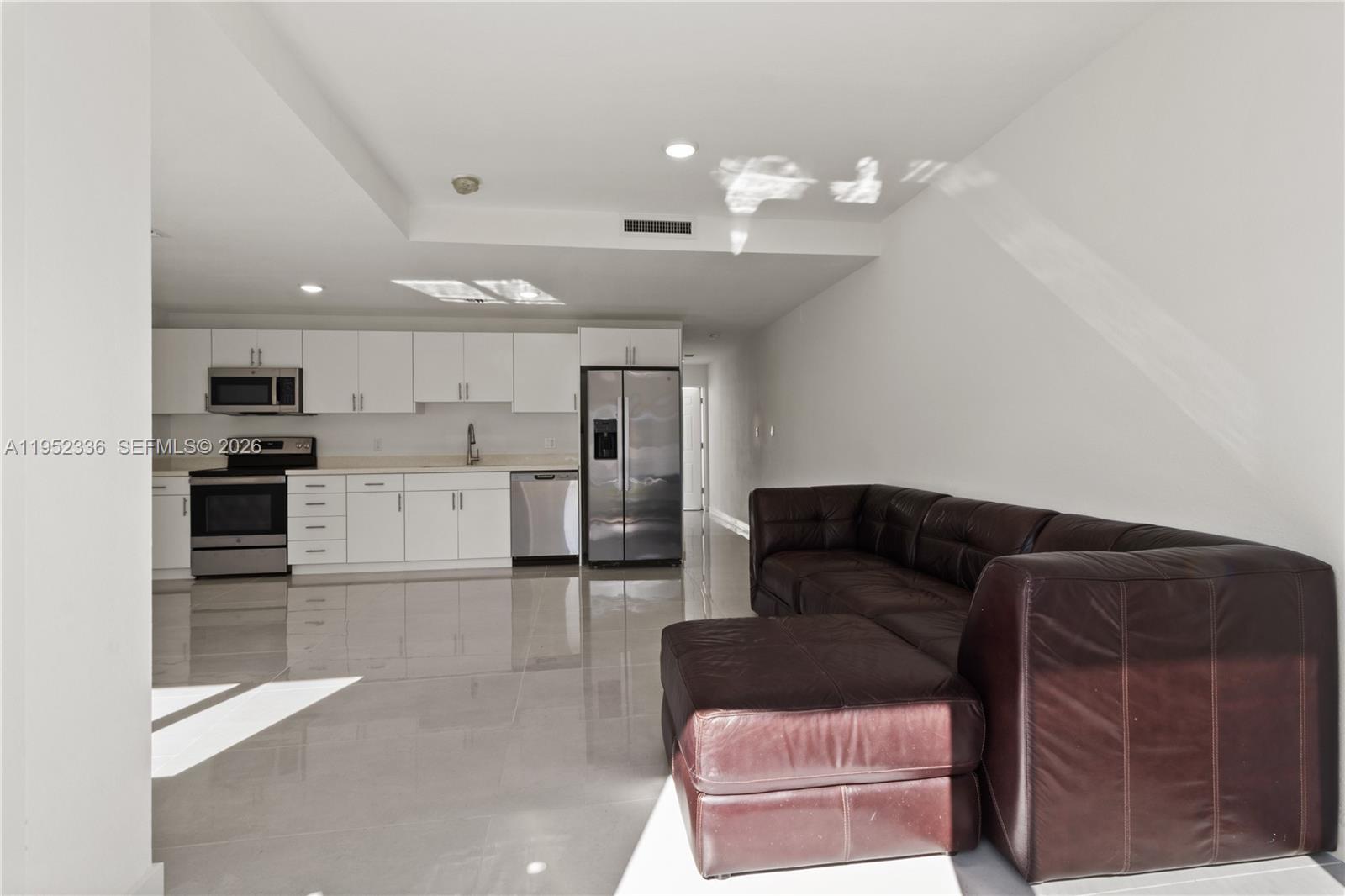 14571 Southwest 261st Street Homestead, FL 33032 - Photo 4 of 30 a living room with furniture and kitchen view