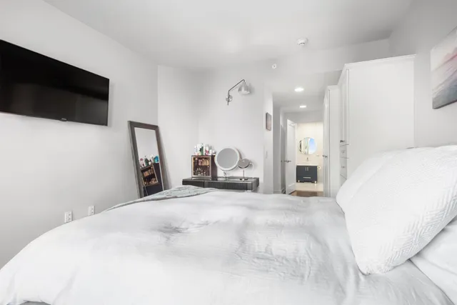 a bedroom with a bed and wooden floor