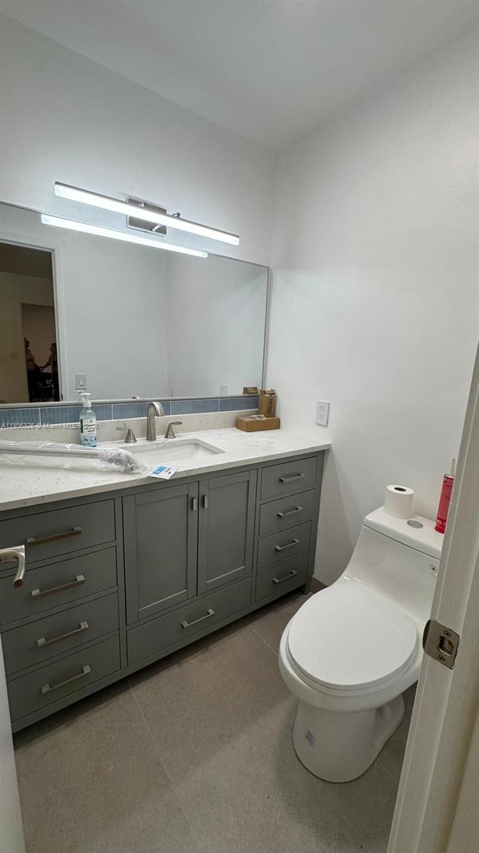 927 Northwest 106th Ave Circle Miami, FL 33172 - Photo 17 of 24 a white toilet sitting next to a bathroom sink