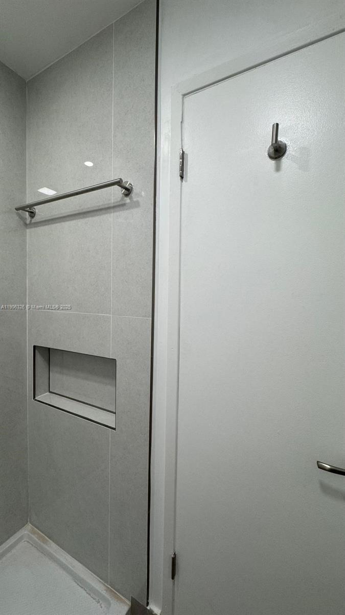 927 Northwest 106th Ave Circle Miami, FL 33172 - Photo 19 of 24 a bathroom with a glass shower door
