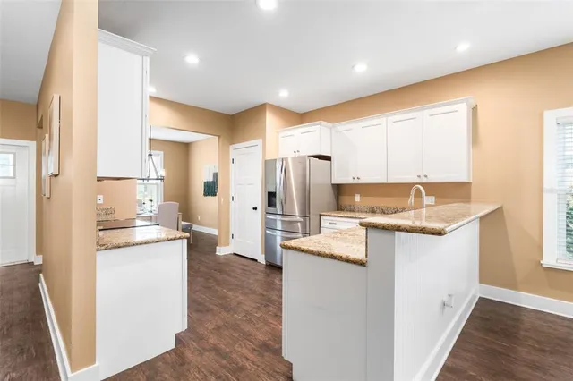 a kitchen with a sink stove and refrigerator