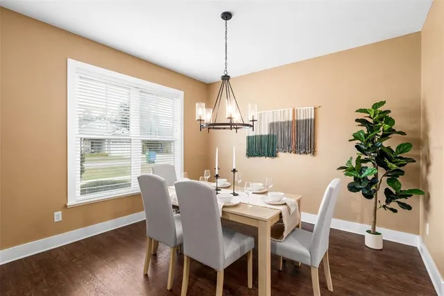 a dining room with furniture window and wooden floor