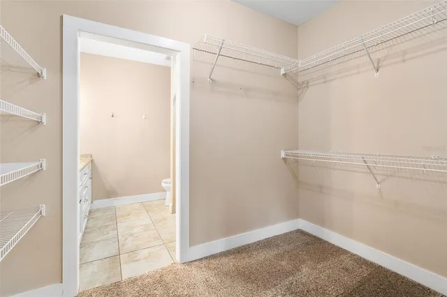 a view of an empty walk in closet with wooden floor
