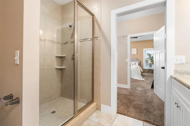 a bathroom with a glass shower door