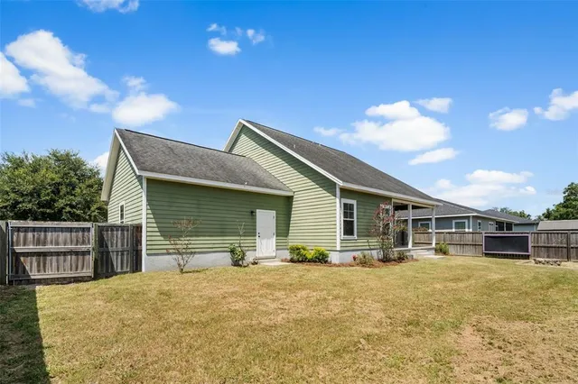 a backyard of a house with table and chairs
