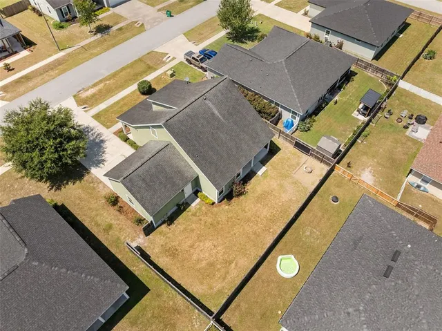 an aerial view of residential house with parking