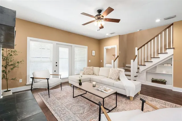 a living room with furniture and a chandelier
