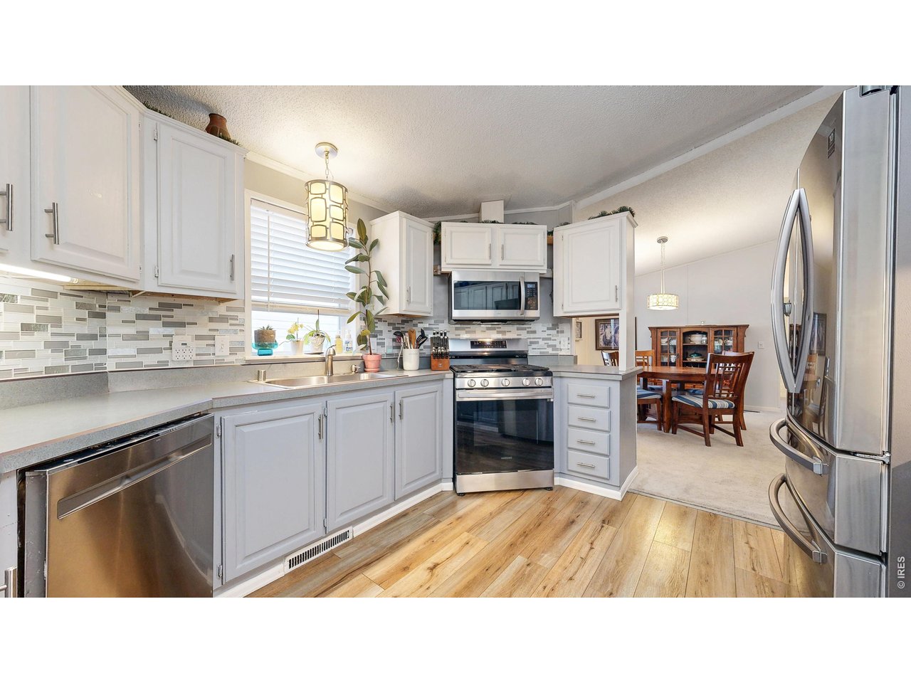 1663 Jade Drive, Unit 151 Loveland, CO 80537 - Photo 5 of 13 Stainless-steel appliances and beautiful tile backsplash