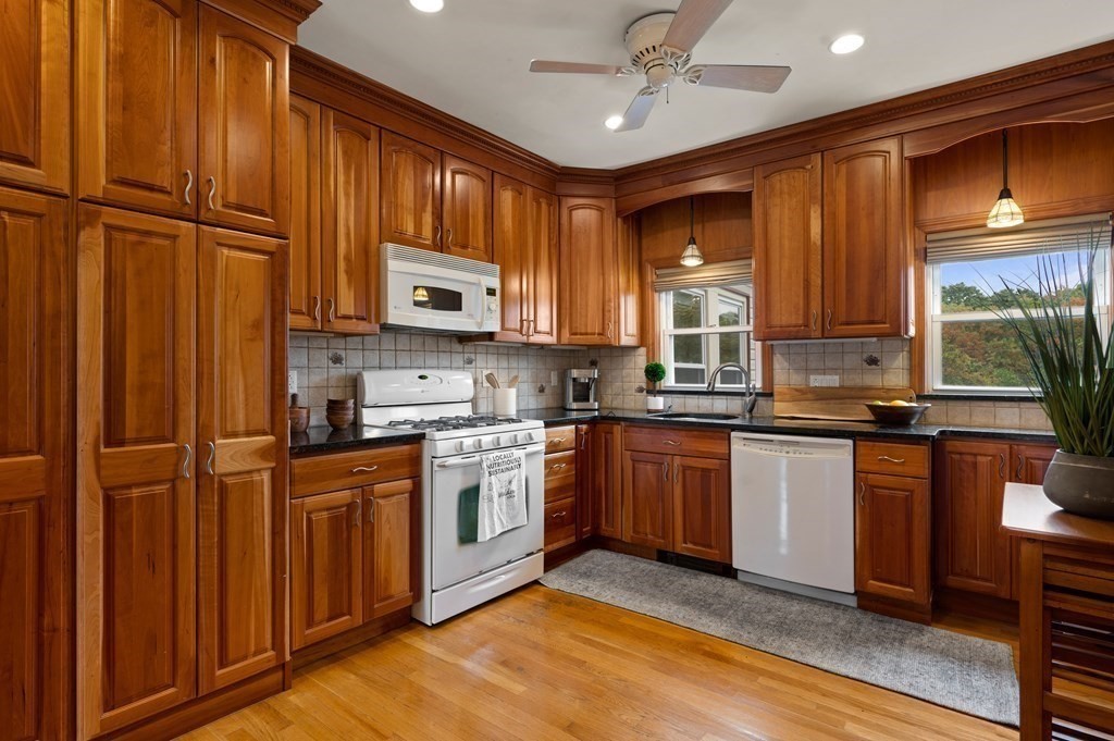 20 Butler Street Medford, MA 02155 - Photo 1 of 29 a kitchen with stainless steel appliances granite countertop wooden cabinets a sink a stove a refrigerator and island with wooden cabinets