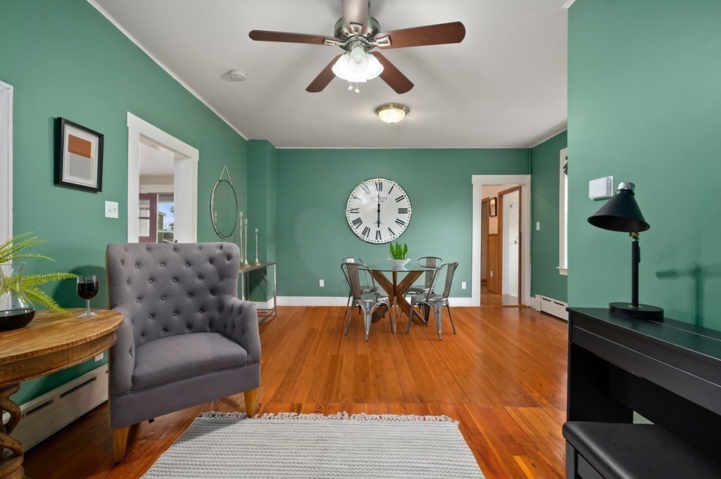 20 Butler Street Medford, MA 02155 - Photo 13 of 29 a living room with furniture a clock and a chandelier