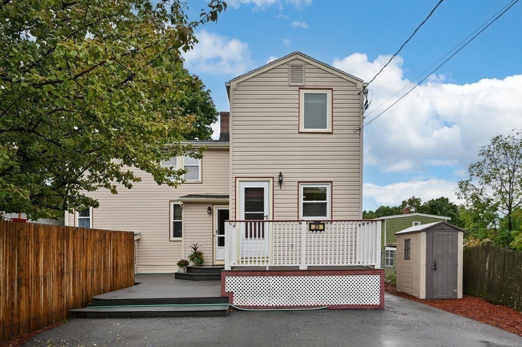 20 Butler Street Medford, MA 02155 - Photo 2 of 29 a view of a house with a large window and wooden fence
