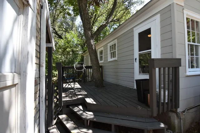 a backyard of a house with table and chairs