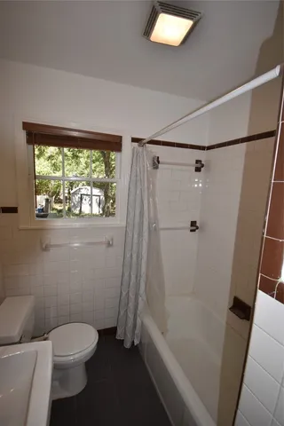 a kitchen with cabinets and window