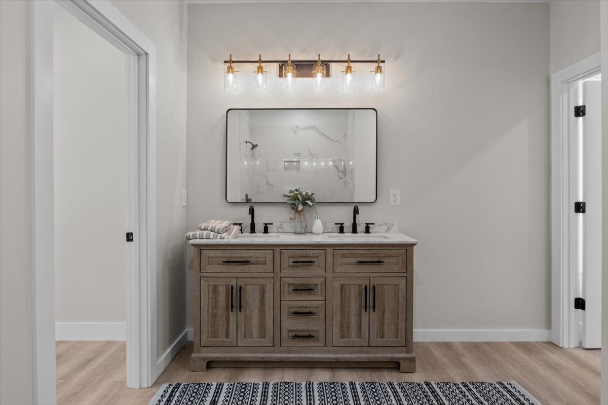 854 Little Leatherwood Road Vanleer, TN 37181 - Photo 20 of 36 a view of a sink and mirror with wooden floor