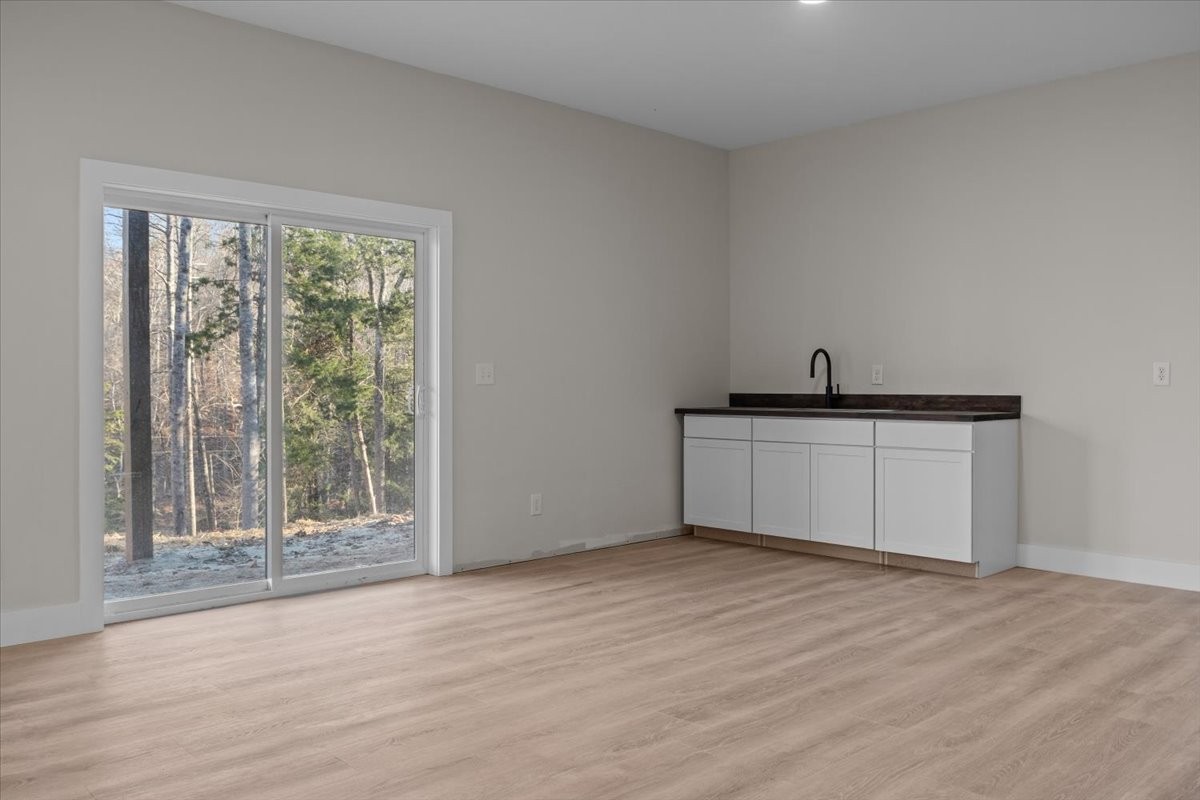 854 Little Leatherwood Road Vanleer, TN 37181 - Photo 27 of 36 a view of a kitchen with wooden floor and a sink
