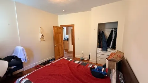 a bedroom with a bed and a mirror