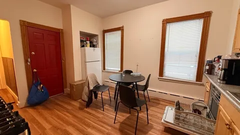 a view of a dining room with furniture and window
