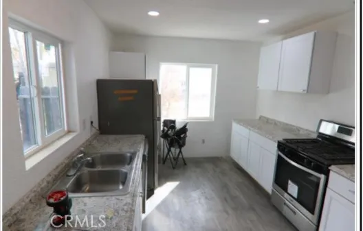 a kitchen with a sink and wooden cabinets