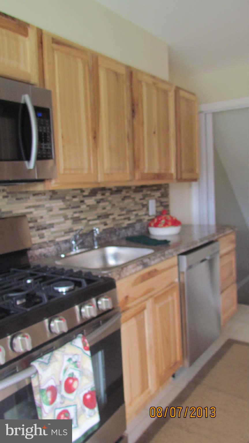 2233 Searles Road Baltimore, MD 21222 - Photo 2 of 15 a kitchen with stainless steel appliances granite countertop a sink and a stove