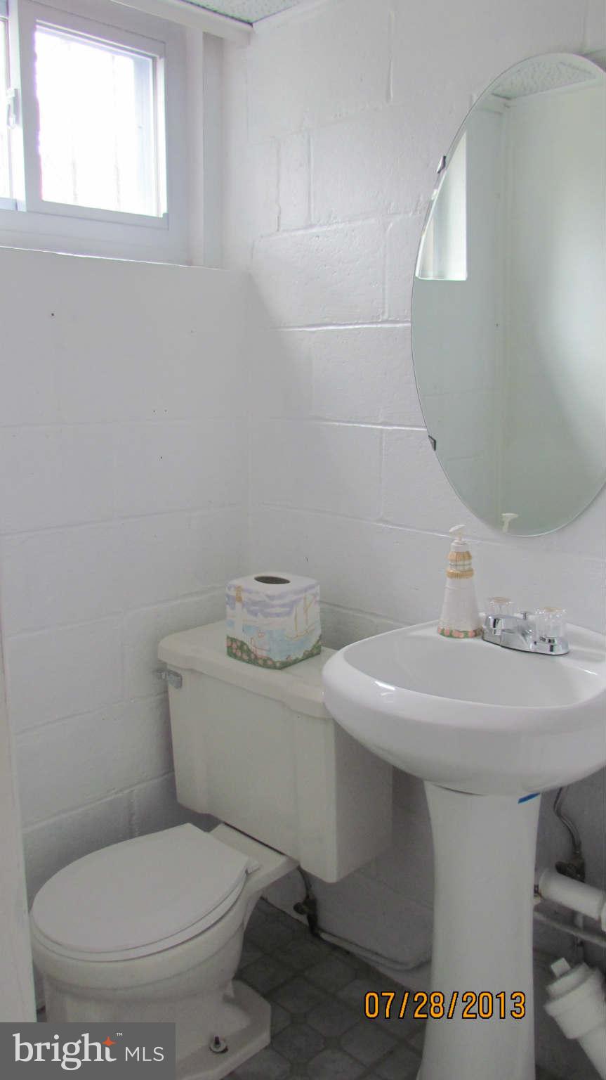 2233 Searles Road Baltimore, MD 21222 - Photo 13 of 15 a bathroom with a toilet sink and mirror