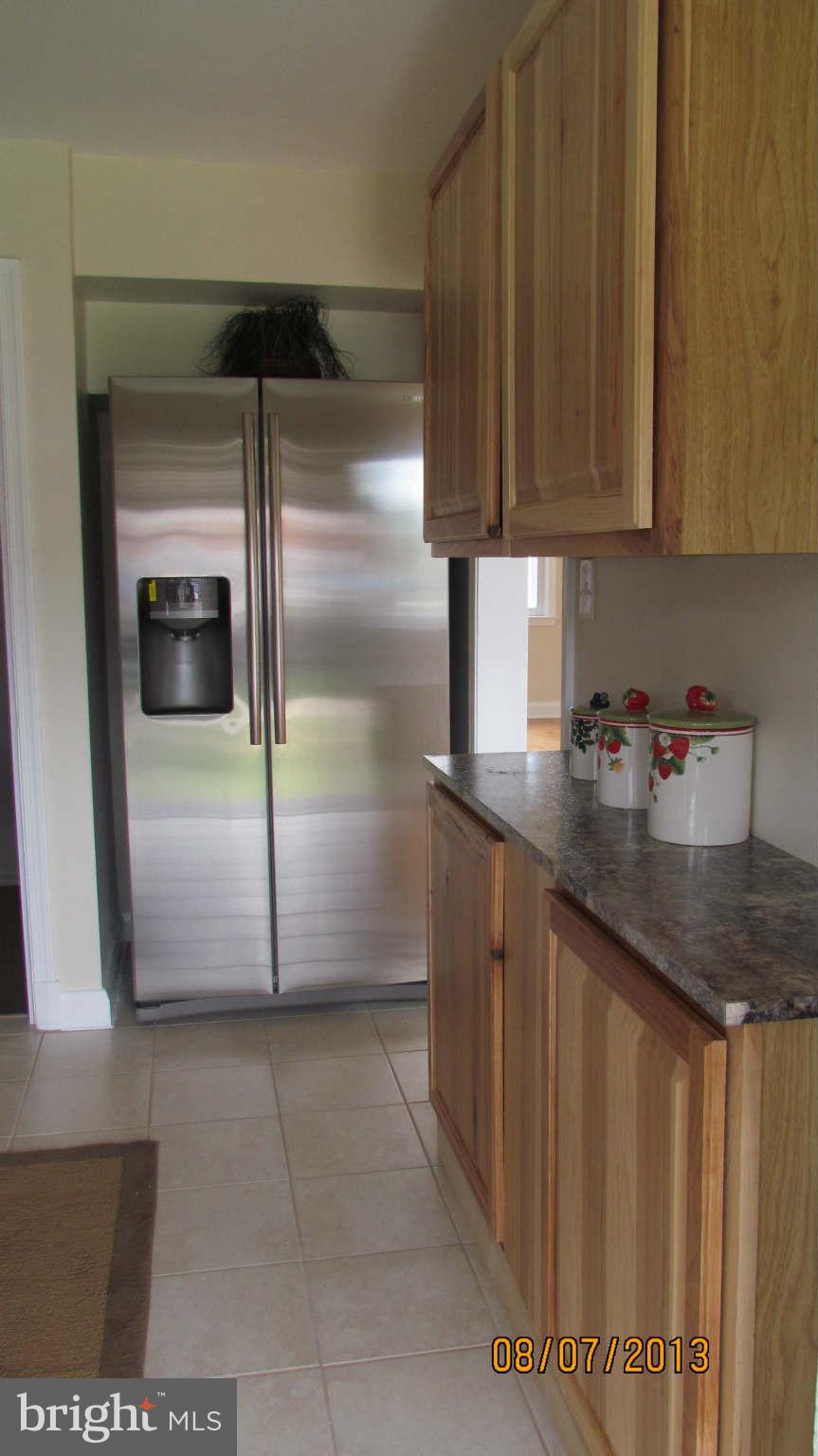 2233 Searles Road Baltimore, MD 21222 - Photo 4 of 15 a kitchen with granite countertop a refrigerator and a sink