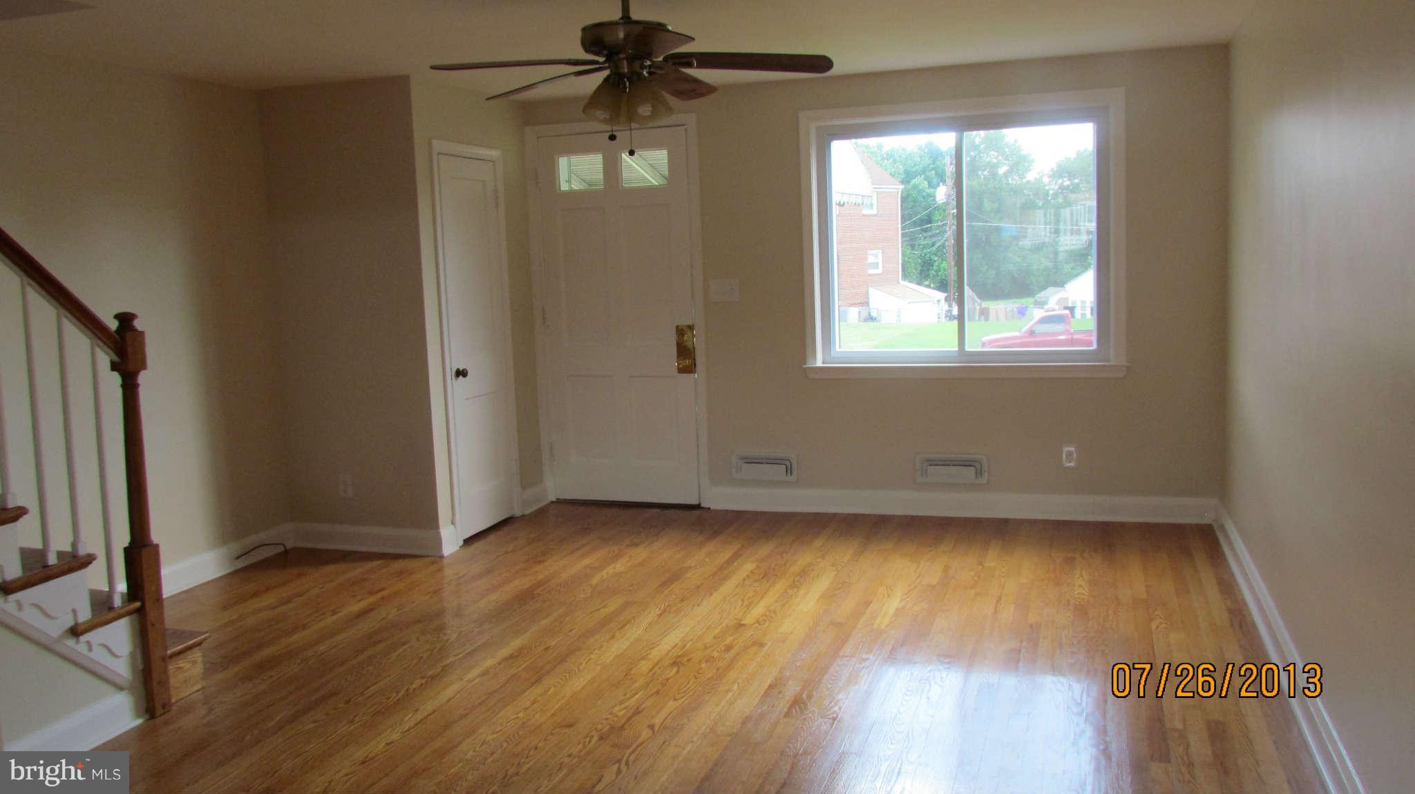 2233 Searles Road Baltimore, MD 21222 - Photo 6 of 15 wooden floor in an empty room with a window