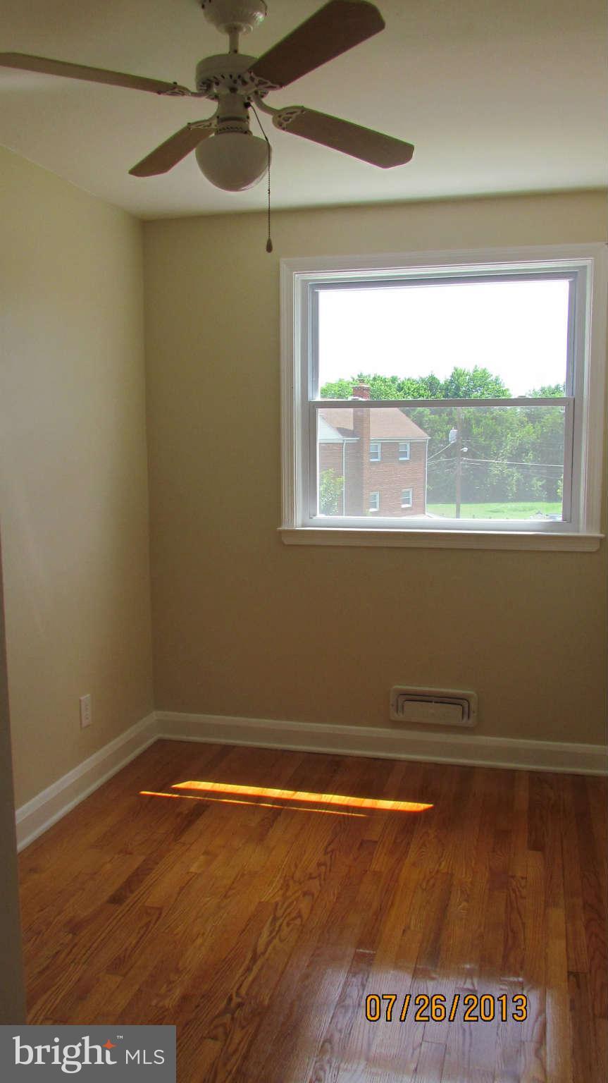 2233 Searles Road Baltimore, MD 21222 - Photo 9 of 15 a view of a room with wooden floor and a window