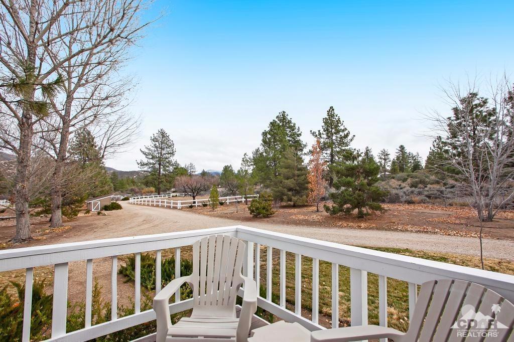 60189 Devils Ladder Road Mountain Center, CA 92561 - Photo 15 of 25 a view of a balcony with wooden floor and fence