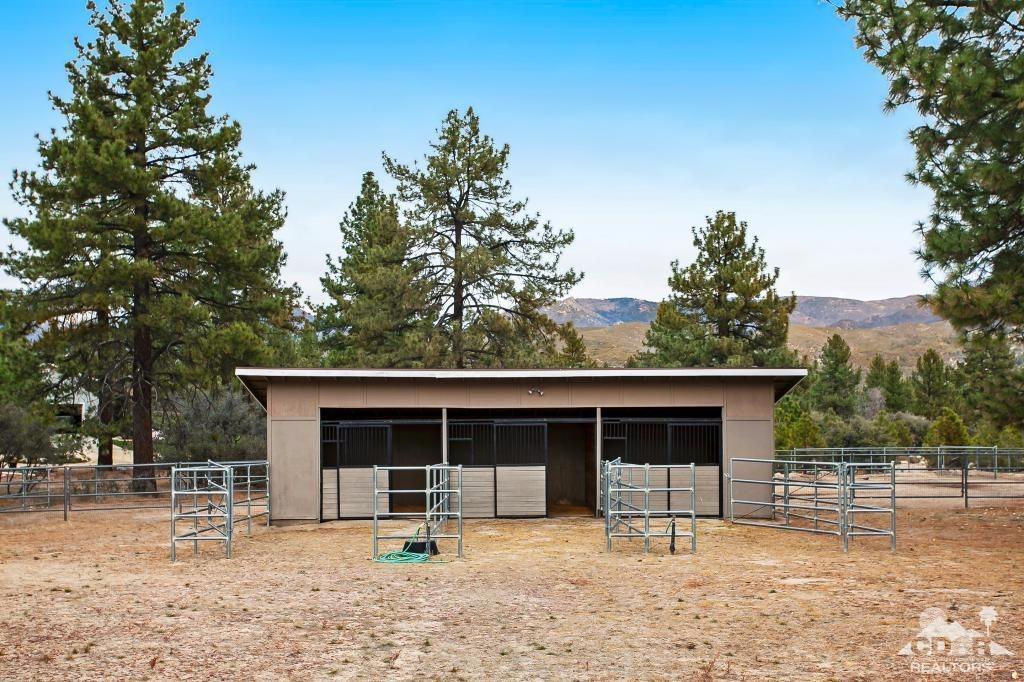 60189 Devils Ladder Road Mountain Center, CA 92561 - Photo 19 of 25 a front view of a house with a yard and garage
