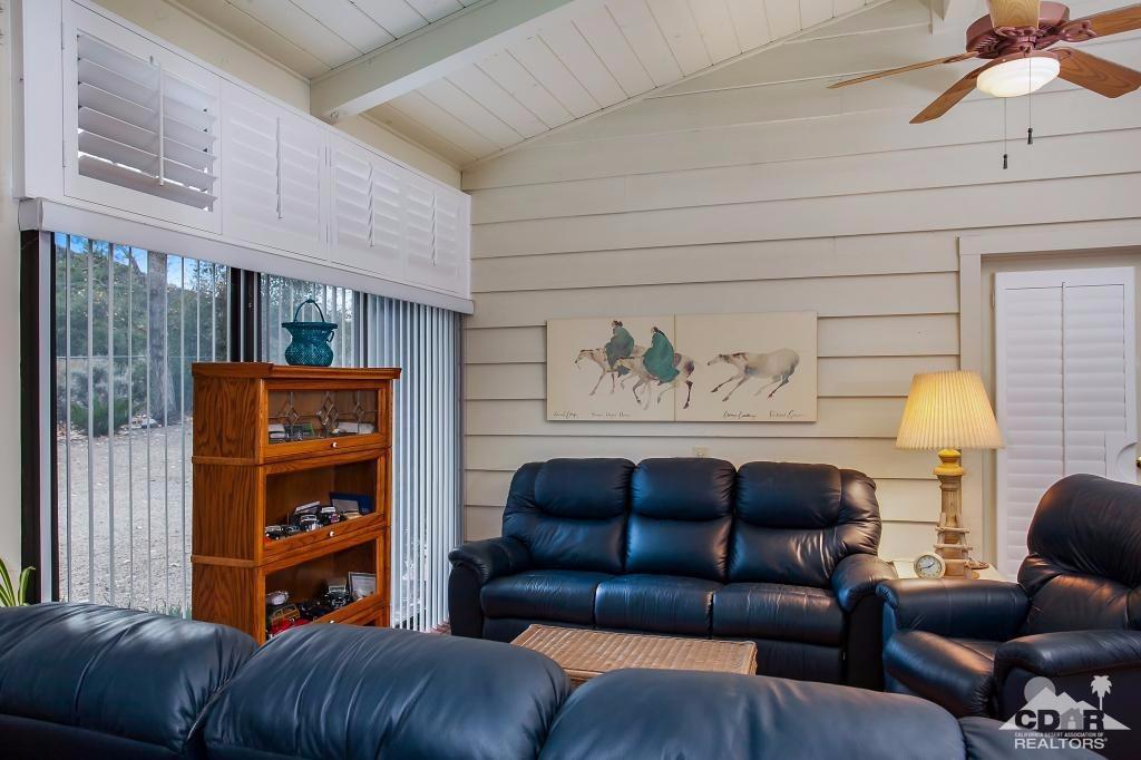 60189 Devils Ladder Road Mountain Center, CA 92561 - Photo 7 of 25 a blue couch sitting in front of a window