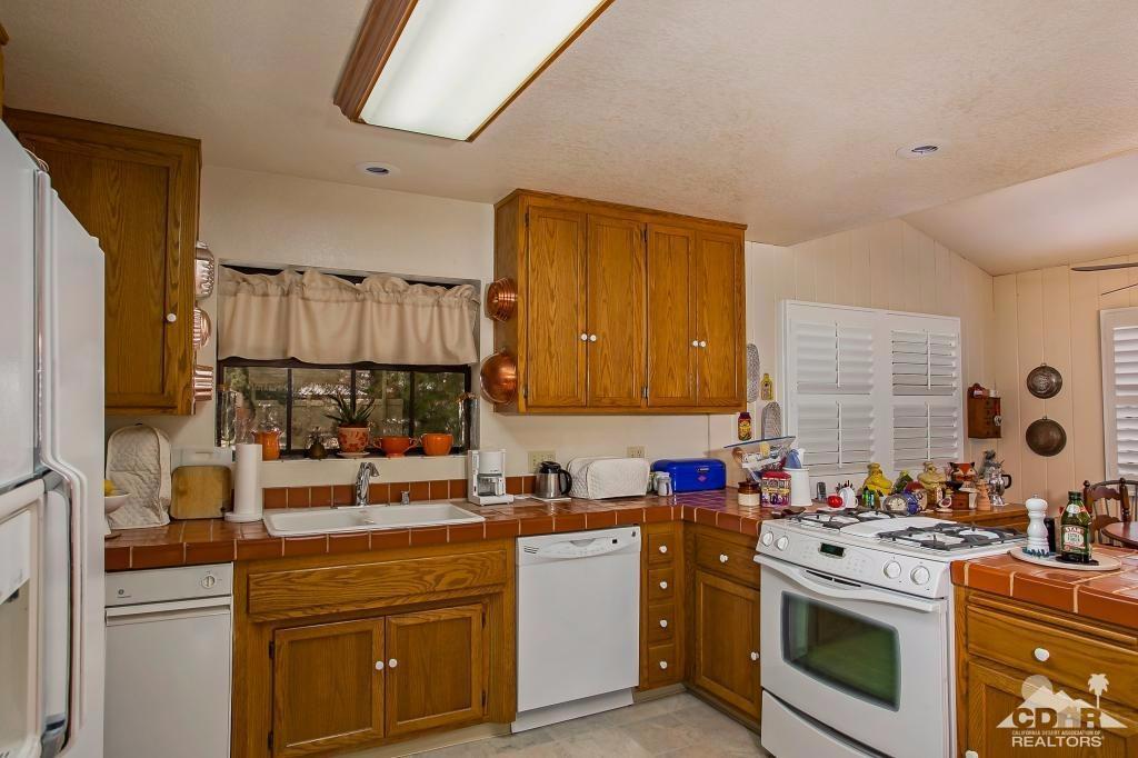 60189 Devils Ladder Road Mountain Center, CA 92561 - Photo 9 of 25 a kitchen with a stove sink and cabinets