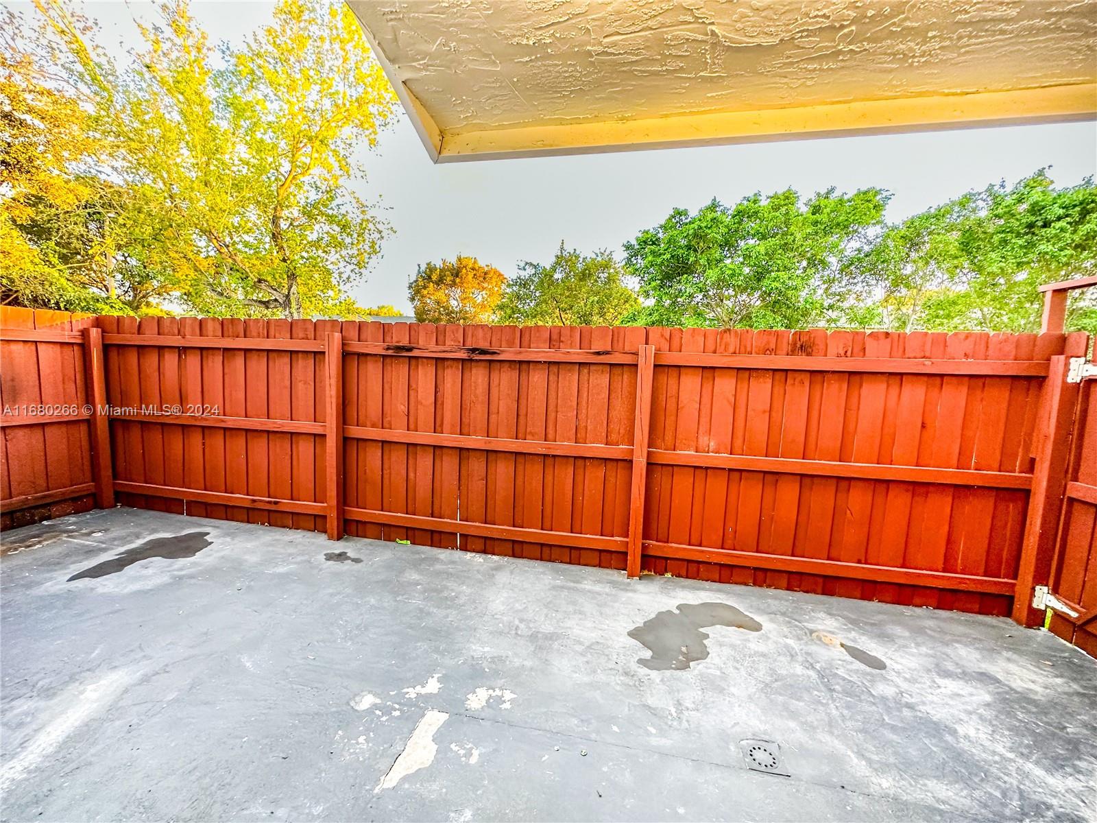13970 Southwest 260th Street, Unit 105 Homestead, FL 33032 - Photo 12 of 31 a view of a backyard with wooden fence