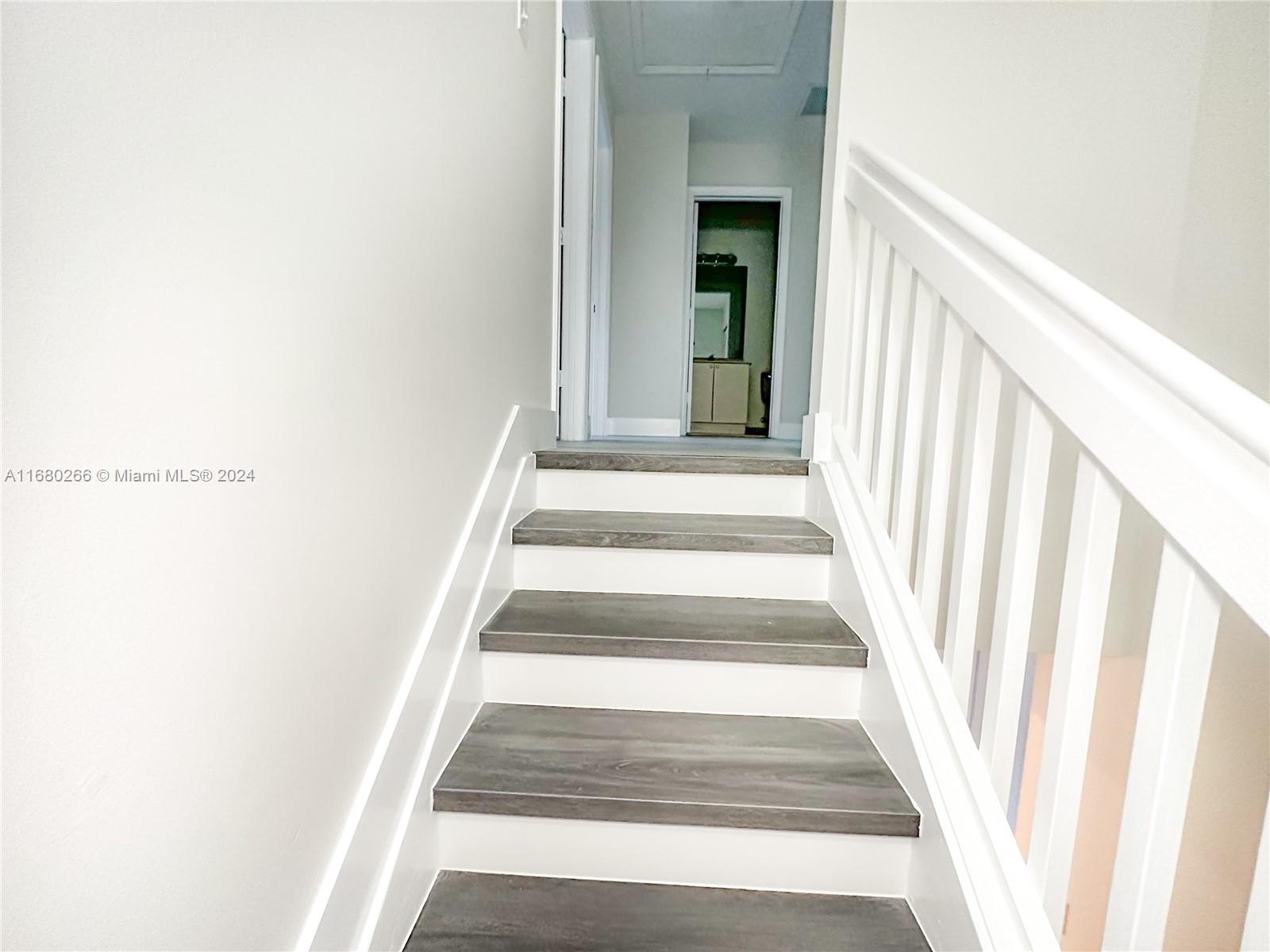 13970 Southwest 260th Street, Unit 105 Homestead, FL 33032 - Photo 16 of 31 a view of staircase with white walls