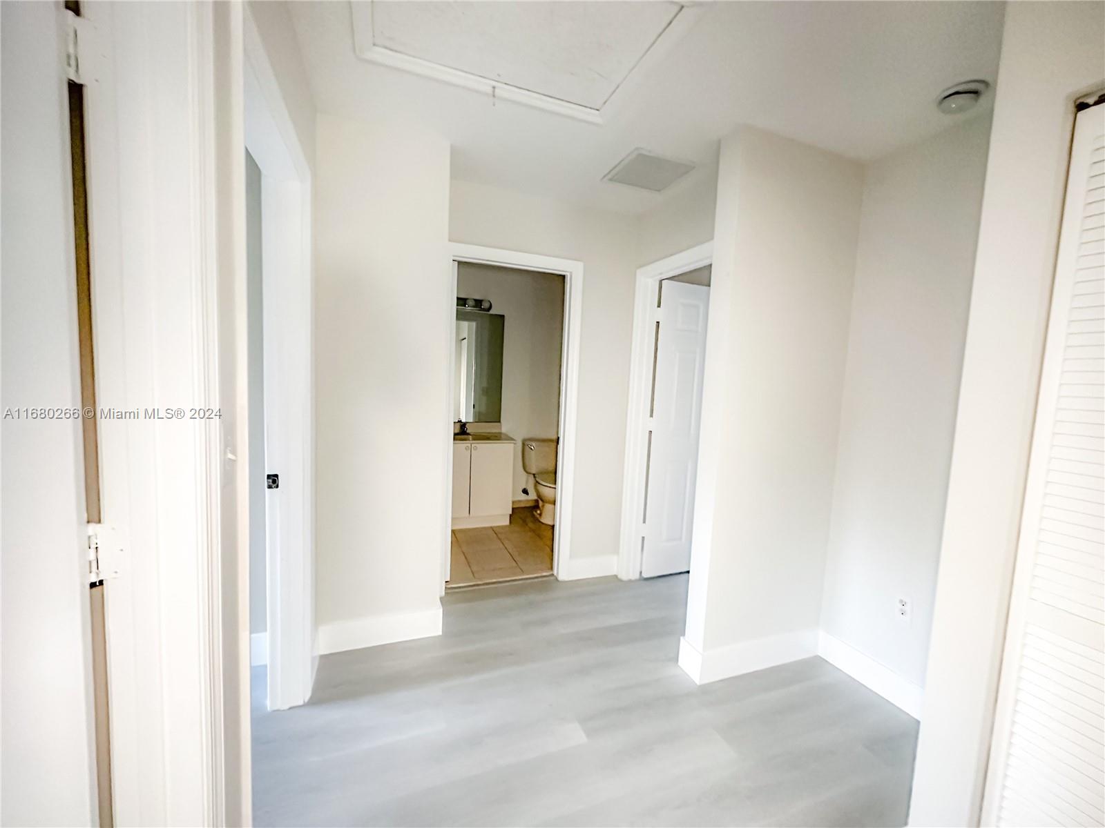 13970 Southwest 260th Street, Unit 105 Homestead, FL 33032 - Photo 17 of 31 a view of a hallway with wooden shelves