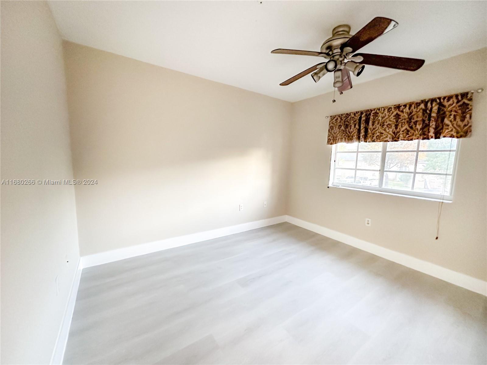 13970 Southwest 260th Street, Unit 105 Homestead, FL 33032 - Photo 18 of 31 a view of empty room with windows