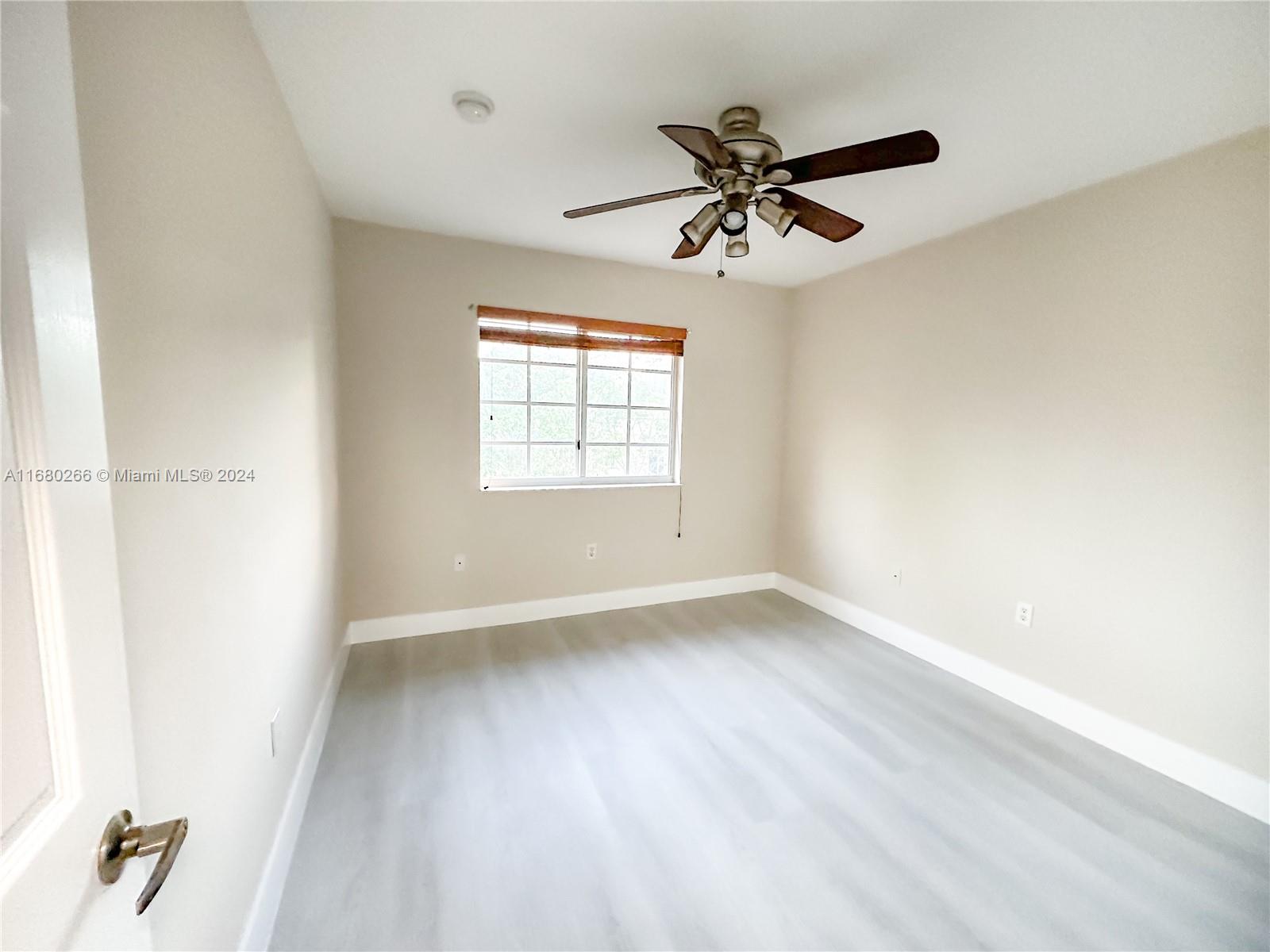 13970 Southwest 260th Street, Unit 105 Homestead, FL 33032 - Photo 20 of 31 a view of empty room with wooden floor and fan