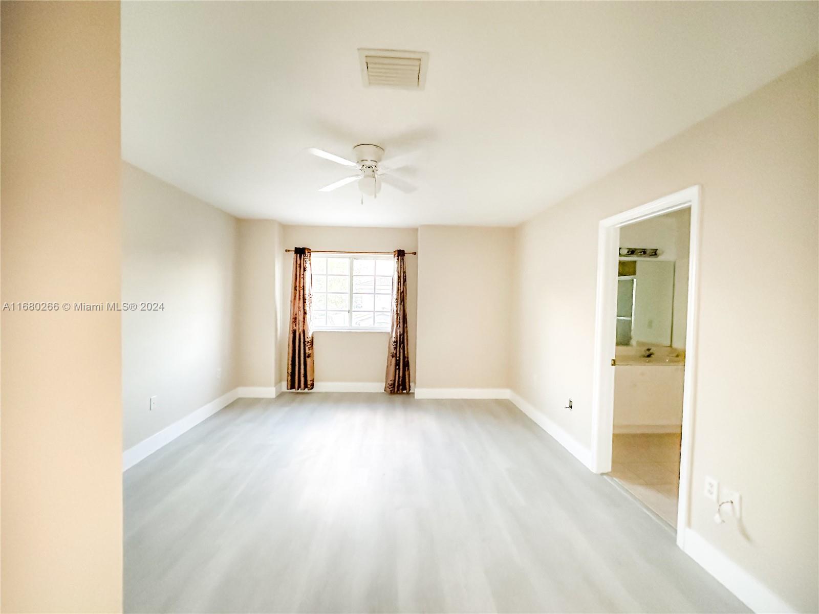 13970 Southwest 260th Street, Unit 105 Homestead, FL 33032 - Photo 23 of 31 a view of empty room with window