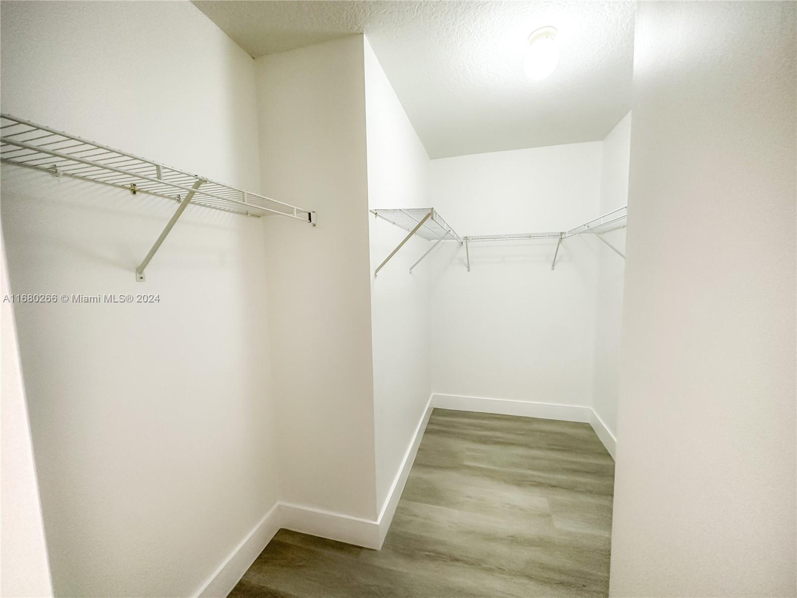 13970 Southwest 260th Street, Unit 105 Homestead, FL 33032 - Photo 24 of 31 a view of a room with racks on the wall