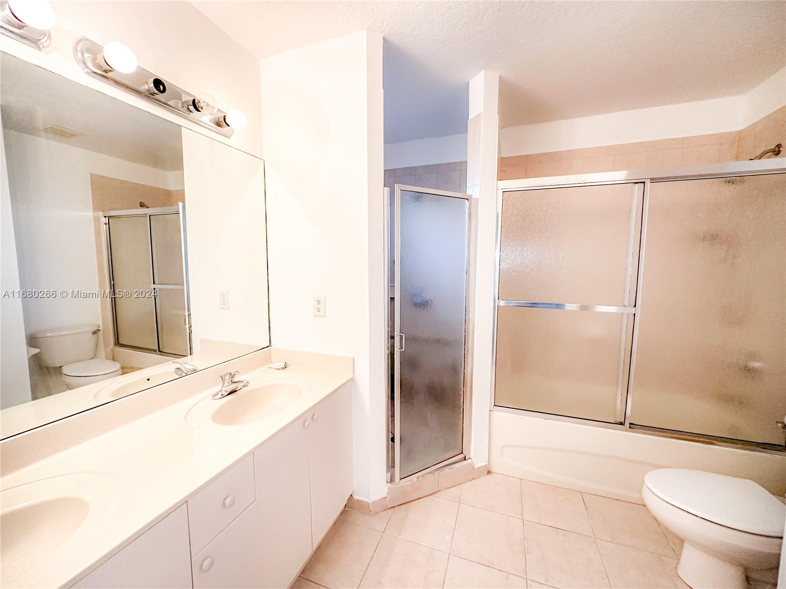 13970 Southwest 260th Street, Unit 105 Homestead, FL 33032 - Photo 25 of 31 a spacious bathroom with a bathtub shower sink and toilet