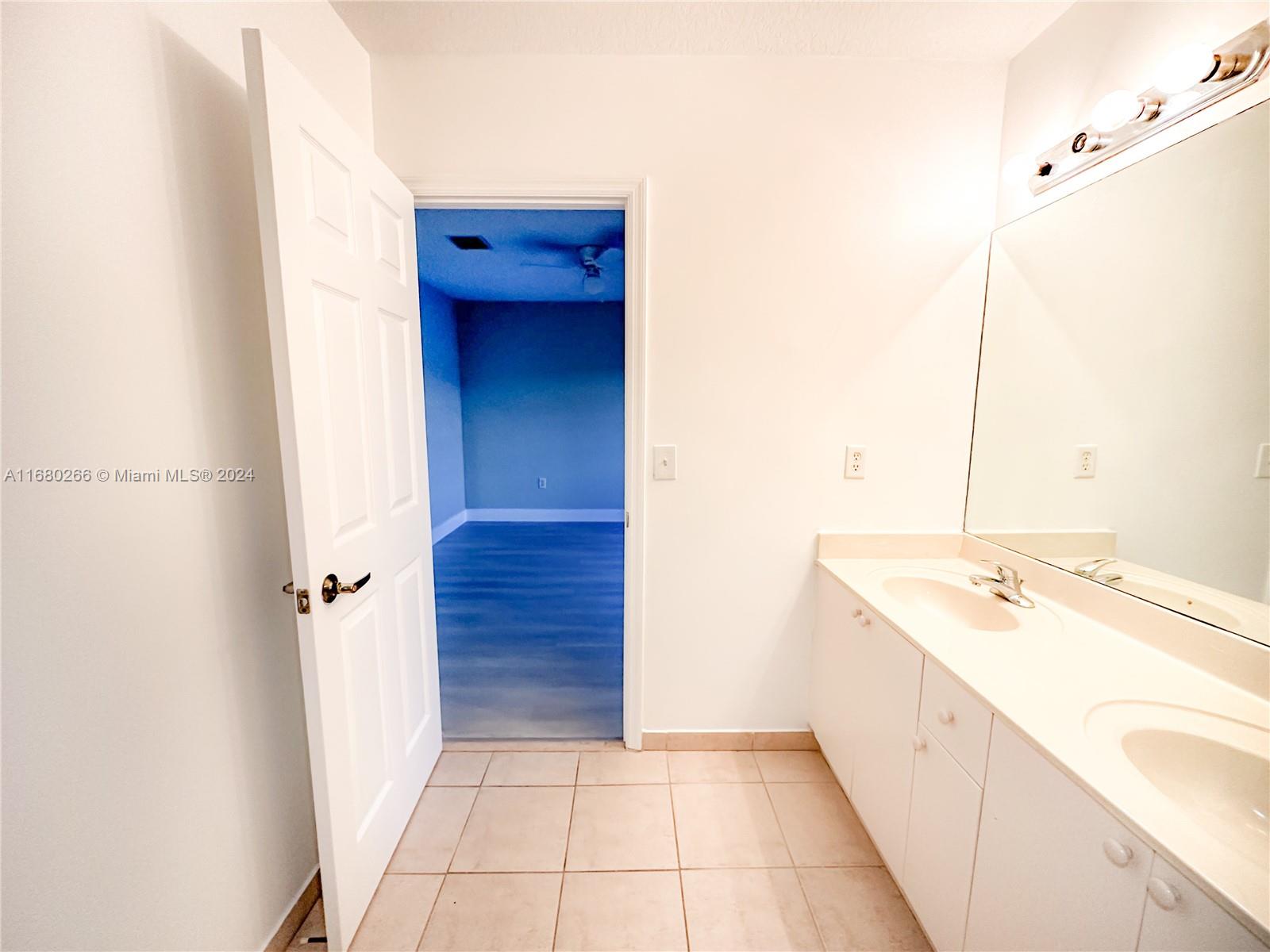 13970 Southwest 260th Street, Unit 105 Homestead, FL 33032 - Photo 26 of 31 a bathroom with a sink and a mirror