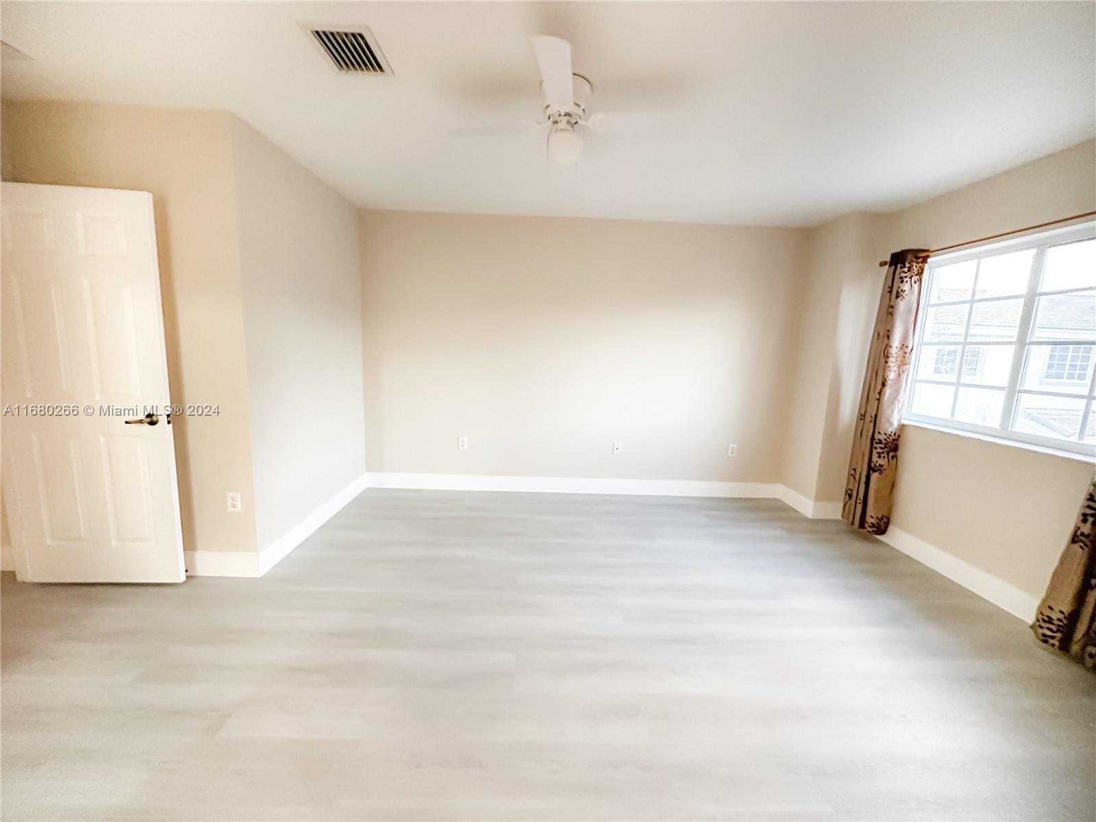 13970 Southwest 260th Street, Unit 105 Homestead, FL 33032 - Photo 28 of 31 an empty room with a window