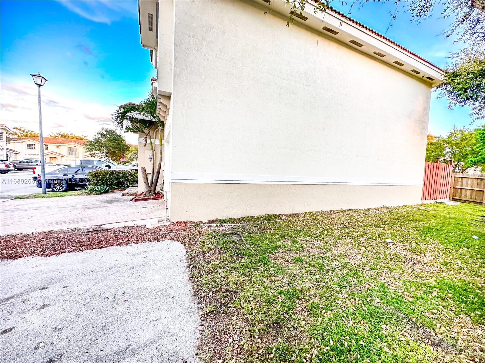 13970 Southwest 260th Street, Unit 105 Homestead, FL 33032 - Photo 30 of 31 a view of a yard with a road