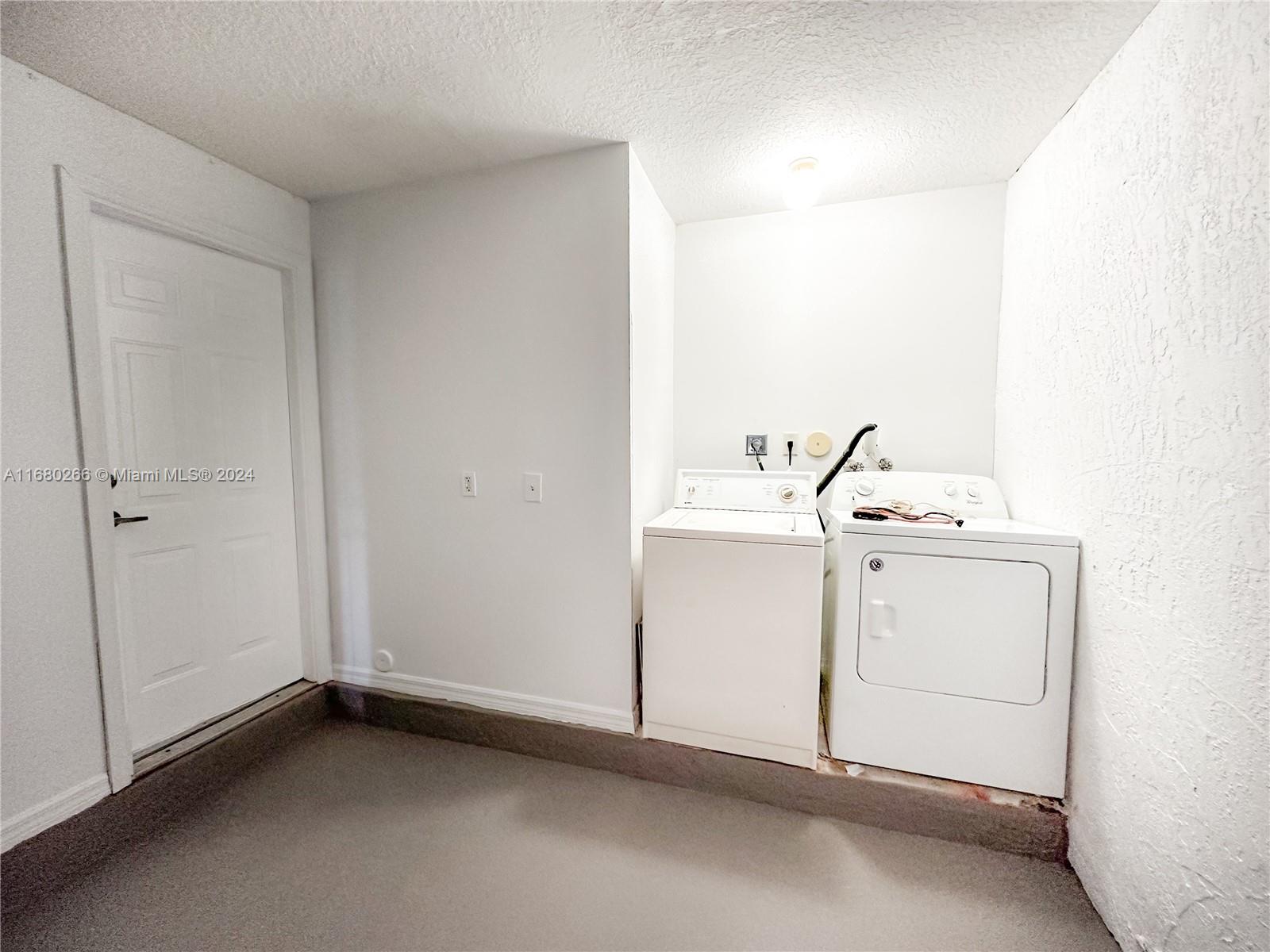 13970 Southwest 260th Street, Unit 105 Homestead, FL 33032 - Photo 7 of 31 a utility room with dryer and washer
