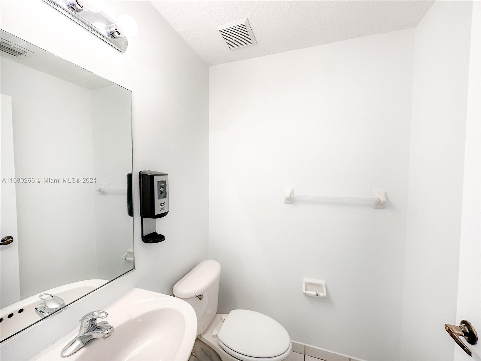 13970 Southwest 260th Street, Unit 105 Homestead, FL 33032 - Photo 8 of 31 a white toilet sitting next to a bathroom sink