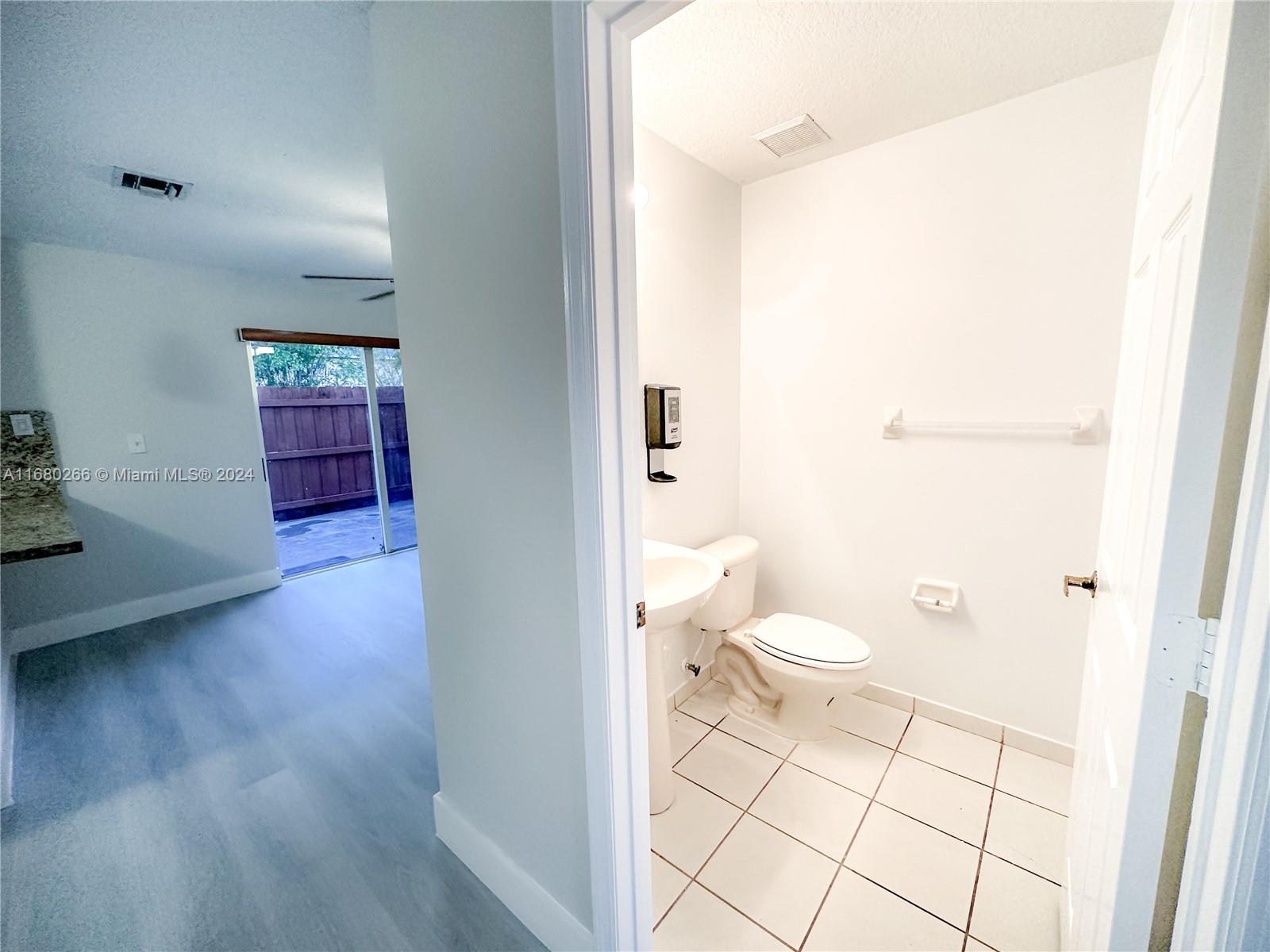 13970 Southwest 260th Street, Unit 105 Homestead, FL 33032 - Photo 9 of 31 a bathroom with a toilet a sink and a shower